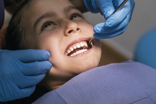 Dentist during a Dental Intervention with a Patient